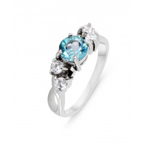 Bague Argent 925 Rhodié Topaze bleue traitée Oxydes Bague sertie 4 oxydes d une Topaze bleue traitée ronde 6mm Serti à gri...