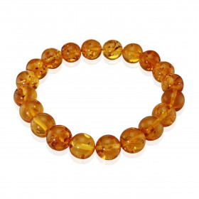  Bracelet ambre sur un fil élastique Ambre couleur cognac Dimension des perles : 10mm Longueur : 18cm 