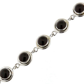 Bracelet en Argent 925 et Grenat. Pierres rondes taillées en cabochon. Diamètre des pierres : 6mm. Largeur du bracelet : 1...