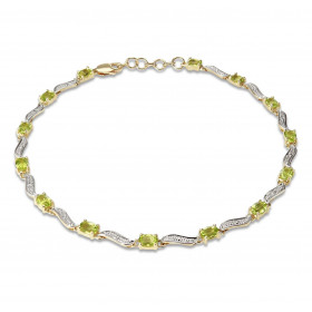 Bracelet en Or Jaune 375 2 tons et Péridots. Ce bracelet est serti de 14 péridots ovales de 4x3mm espacés par des motifs o...