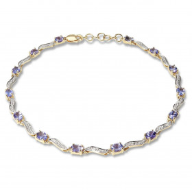 Bracelet en Or Jaune 375 2 tons et Tanzanites. Ce bracelet est serti de 14 tanzanites ovales de 4x3mm espacées par des mot...