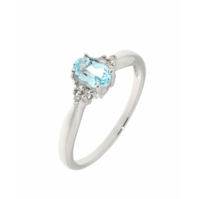 Solitaire Topaze Bleue Traitée et Diamant en Or Blanc 375. Cette jolie monture est ornée d'une pierre ovale de 6x4mm. 3 pe...